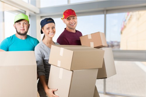A family organizing household items for storage in Surbiton