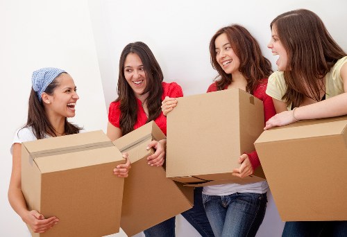 Professional team managing a flat move in Surbiton stairwell