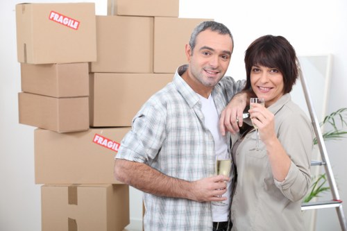 Movers carrying furniture through a narrow hallway